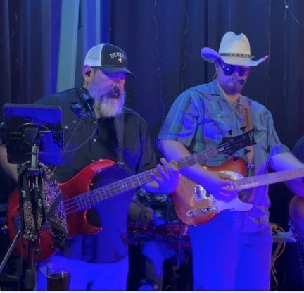 Bass player singing into the mic with the frontman alongside him.